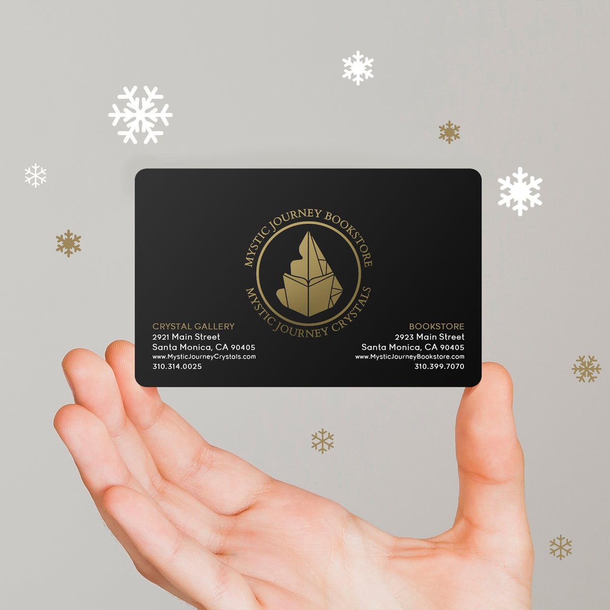 A hand holds up a Mystic Journey Crystals gift card